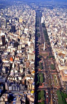 an aerial view of a city with lots of tall buildings and roads in the foreground