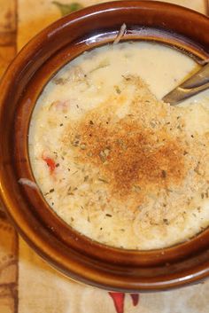 a brown bowl filled with soup on top of a table