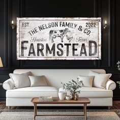 a living room filled with furniture and a large sign on the wall above it's couch