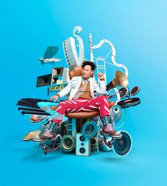 a man sitting on top of a chair surrounded by musical instruments and music equipment in front of a blue background