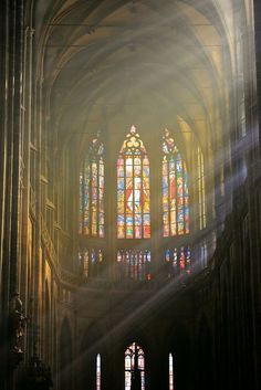 sunlight shining through the stained glass windows in a cathedral