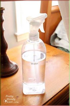 a bottle of water sitting on top of a wooden table