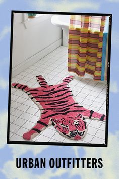 a pink tiger rug sitting on top of a bathroom floor