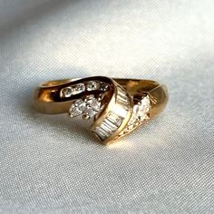 Vintage 1970s 14k solid gold ribbon style statement ring Features brilliant, baguette and marquee cut natural diamonds 0.25ctw approx with prong and tension settings Size: US 7.5 Total ring weight: 3.84g (approx) Condition: Ring is in near mint condition with little to no signs of wear Ribbon Style, Diamond Ribbon, Natural Diamond Ring, Gold Ribbon, Gold Ribbons, Style Statement, Vintage Diamond, Vintage 1970s, Solid Yellow