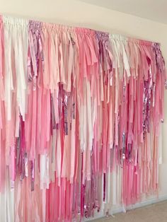 pink and white streamers hanging on the wall