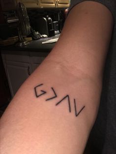 a person with a tattoo on their arm that has the letters v and n in black ink