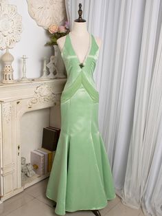 tep into a world of timeless elegance with our Light Green Cutout Back V-neck Vintage Mermaid Skirt Gown. This enchanting gown features a soft, light green hue that exudes a fresh and delicate charm. The V-neckline accentuates your décolletage, adding a touch of sophistication to the overall look. ​The gown boasts a mermaid silhouette, hugging your curves and flaring out gracefully at the hem, creating a stunning, vintage-inspired shape. The cutout back design adds a modern twist, ensuring you m Elegant V-neck Pageant Dress, Fitted V-neck Mermaid Dress With Sweep Train, Embellished V-neck Mermaid Wedding Dress, Elegant V-neck Gown For Pageants, Elegant Mermaid Dress With Sweep Train For Pageants, Elegant Satin Evening Dress For Pageant, Elegant Mermaid Dress With Sweep Train For Pageant, Fitted Green Evening Dress For Pageant, Elegant Green Gown For Pageants