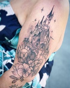 a woman with a castle tattoo on her arm