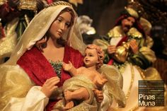 a nativity scene with figurines of jesus and mary holding a baby jesus