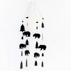 a mobile with bears and trees hanging from it