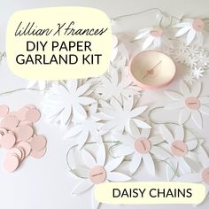 diy paper garland kit with daisy chains and ball on it, surrounded by flowers