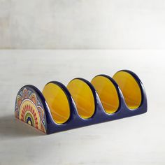 three blue and yellow traffic lights sitting on top of a white table next to each other