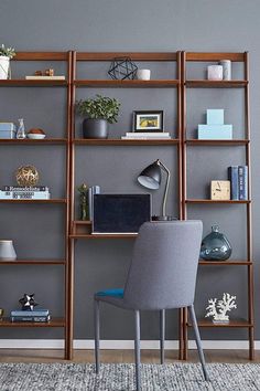 a chair sitting in front of a book shelf