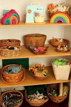 the shelves are filled with baskets, toys and other items for playtime or storage