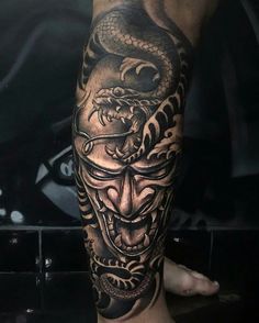 a man's leg with a tattoo on it that has a dragon in the middle