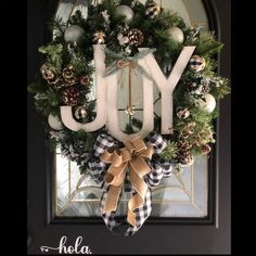 a wreath with the word joy hanging on it