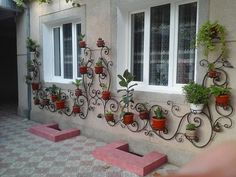 several different types of flower pots on the side of a building