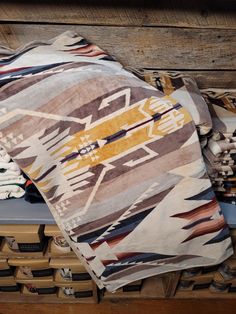 a pile of blankets sitting on top of a wooden crate