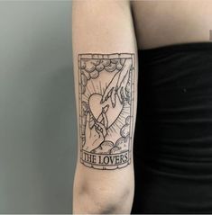 a woman's arm with a tattoo on it that reads, the lovers and an image of a dove