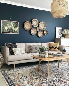 a living room filled with furniture and lots of pictures hanging on the wall above it