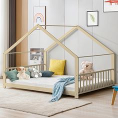 a child's bed with a house shaped frame and stuffed animals on the bottom