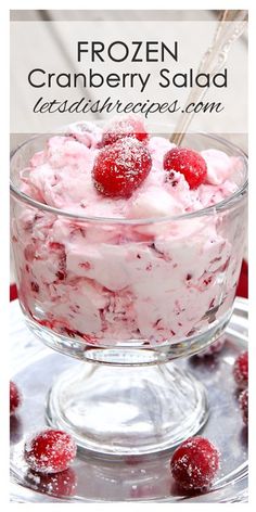 a glass bowl filled with ice cream and raspberries on top of a plate