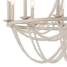 a white chandelier with wooden beads hanging from it's arms and two candles on each end