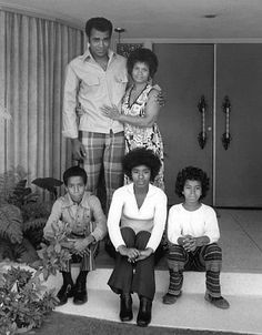 a black and white photo of people sitting on steps