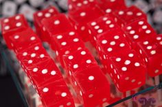 red dices with white polka dots on them sitting in a display case at a casino