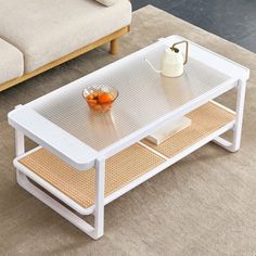 a white coffee table sitting on top of a rug