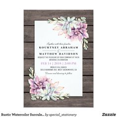 a wedding card with watercolor succulents and leaves on it, sitting on top of a wooden table