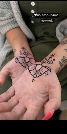 a woman's hand with tattoos on it