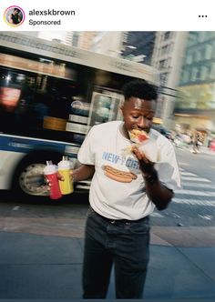 a man standing on the street eating food