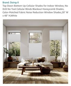 a living room filled with furniture and windows covered in white roller shade shades on top of them