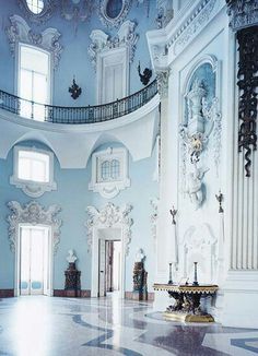 an ornately decorated room with blue walls and marble floors