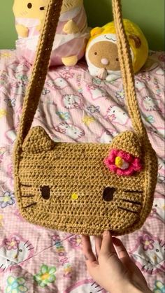 a crocheted purse with a cat face on it