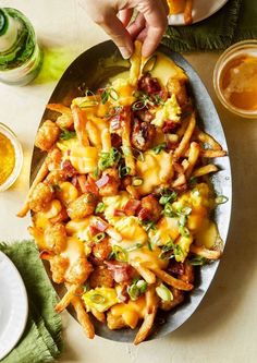 a plate full of cheesy pasta and some beer