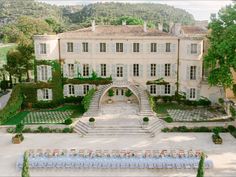 an aerial view of a wedding venue in front of a large mansion with stone steps leading up to the entrance