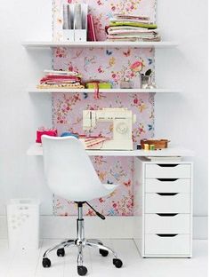 a white desk chair sitting in front of a book shelf