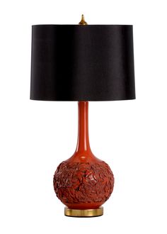 a red table lamp with a black shade