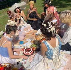 a group of women sitting around a picnic table