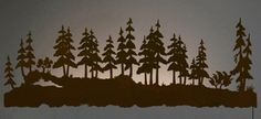 the silhouettes of trees are shown against a dark background