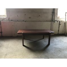 a wooden table sitting in an empty room