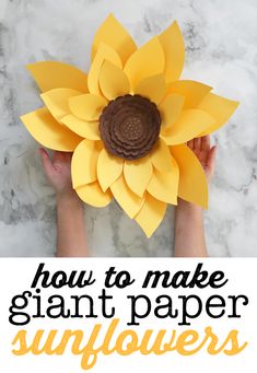 someone holding up a paper sunflower with the words how to make giant paper sunflowers