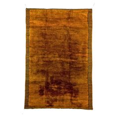 an orange and brown rug with fringes on the bottom, against a white background