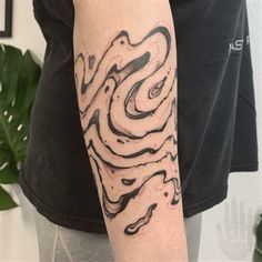 a person with a black and white tattoo on their arm