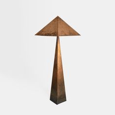 a tall metal lamp with a brown shade on it's top and bottom part