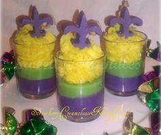 four glasses filled with yellow and purple cake