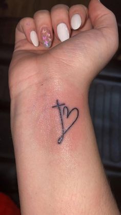 a woman's arm with a small tattoo on it that says i love you