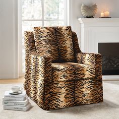 a tiger print chair next to a stack of books in front of a fire place